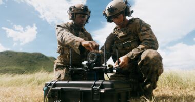 Soldiers load a simulated warhead onto a Neros Archer first-person view drone during attack drone training.