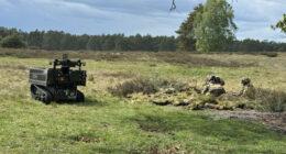 Soldiers operating alongside an X Series unmanned ground vehicle
