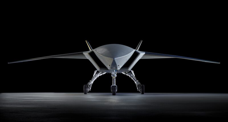 Boeing MQ-28 Ghost Bat autonomous combat drone front view on hangar floor, showing low-observable flying wing design and tricycle landing gear
