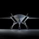 Boeing MQ-28 Ghost Bat autonomous combat drone front view on hangar floor, showing low-observable flying wing design and tricycle landing gear