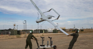 U.S. Marine Corps Lance Cpl. Isaiah Trujillo, an unmanned aircraft system (UAS) maintenance technician with Marine Unmanned Aerial Vehicle Squadron (VMU) 3, Marine Aircraft Group (MAG) 24, 1st Marine Aircraft Wing (MAW), and Lance Cpl. Mario Mendoza, a UAS maintenance technician with VMU-1, MAG-13, 3rd MAW, recover a U.S. Marine Corps RQ-21A Blackjack aircraft during Weapons and Tactics Instructor (WTI) course 1-20 at Canon Air Defense Complex in Yuma, Arizona, Sept. 26, 2019. WTI is a seven week training event hosted by Marine Aviation Weapons and Tactics Squadron One (MAWTS-1), which emphasizes operational integration of the six functions of Marine Corps Aviation in support of a Marine Air Ground Task Force. WTI also provides standardized advanced tactical training and certification of unit instructor qualifications to support Marine Aviation training and readiness, and assists in developing and employing aviation weapons and tactics. (U.S. Marine Corps photo by Cpl. Adaezia Chavez)
