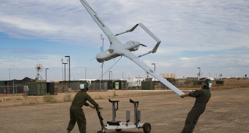 U.S. Marine Corps Lance Cpl. Isaiah Trujillo, an unmanned aircraft system (UAS) maintenance technician with Marine Unmanned Aerial Vehicle Squadron (VMU) 3, Marine Aircraft Group (MAG) 24, 1st Marine Aircraft Wing (MAW), and Lance Cpl. Mario Mendoza, a UAS maintenance technician with VMU-1, MAG-13, 3rd MAW, recover a U.S. Marine Corps RQ-21A Blackjack aircraft during Weapons and Tactics Instructor (WTI) course 1-20 at Canon Air Defense Complex in Yuma, Arizona, Sept. 26, 2019. WTI is a seven week training event hosted by Marine Aviation Weapons and Tactics Squadron One (MAWTS-1), which emphasizes operational integration of the six functions of Marine Corps Aviation in support of a Marine Air Ground Task Force. WTI also provides standardized advanced tactical training and certification of unit instructor qualifications to support Marine Aviation training and readiness, and assists in developing and employing aviation weapons and tactics. (U.S. Marine Corps photo by Cpl. Adaezia Chavez)