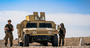 U.S. Air Force Airman 1st Class Dane Brouillette and Airman 1st Class Alyssa Richardson, 379th Expeditionary Security Forces Squadron installation patrollers, exit a Humvee during a Tactical Leadership Course within the U.S. Central Command area of responsibility, Jan. 20, 2025. Airmen were evaluated on their ability to respond effectively to simulated attacks or security incidents within the installation. (U.S. Air Force photo by Airman 1st Class Zeeshan Naeem)